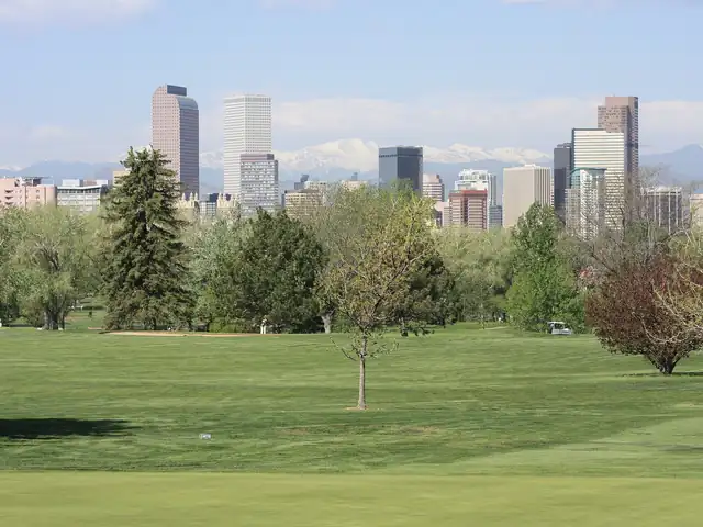 Downtown Denver skyline from City Park with the Rocky Mountains behind