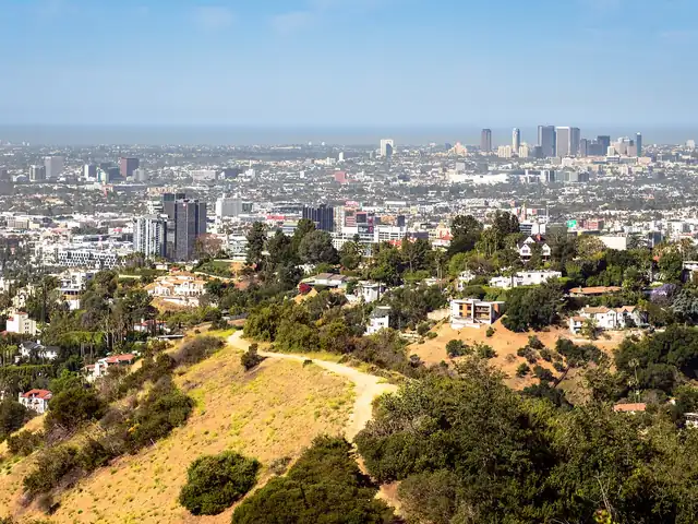 Los Angeles seen from the hills, with the city skyline in the distance. Flights from Denver to Los Angeles