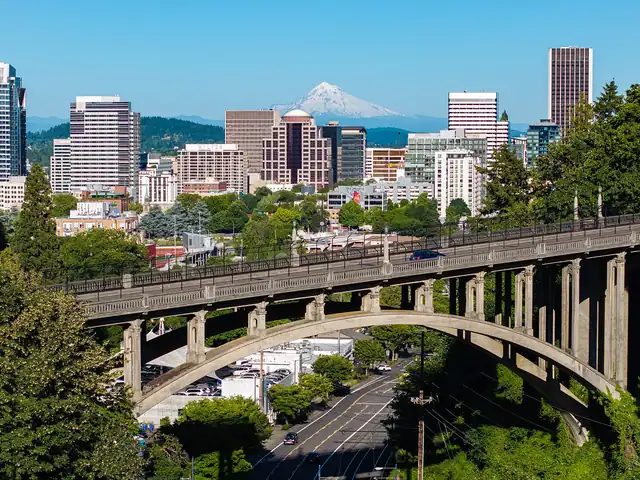 Downtown Portland with the Vista Bridge and Mount Hood. Flights from Denver to Portland