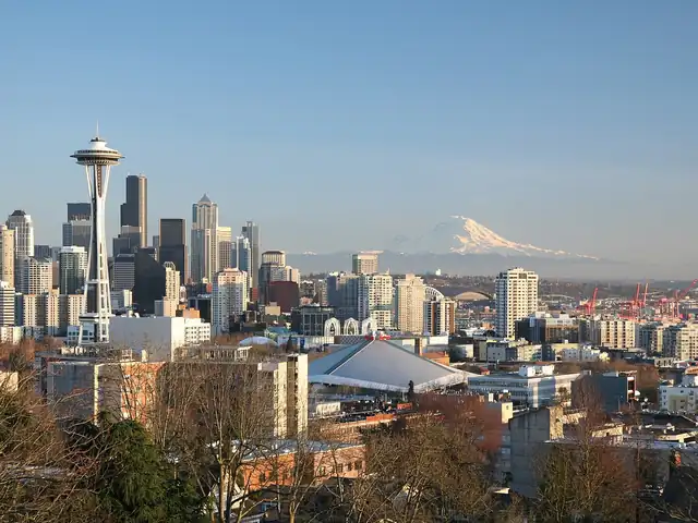 Seattle skyline with the Space Needle and Mount Rainier, seen from Queen Anne Hill. Flights from Seattle to Detroit